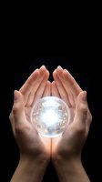 Hands holding glowing digital sphere with circuit board pattern against black background, representing technology innovation, future solutions, and digital transformation for business concepts.