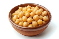 Cooked chickpeas in traditional clay bowl on white background. Golden garbanzo beans in olive oil, ready for Mediterranean and Middle Eastern cuisine preparation.