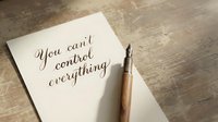 Motivational handwritten quote on white paper with elegant pen on wooden desk surface for inspiration and personal development content.