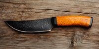 Handcrafted butcher knife with forged damascus steel blade and polished wooden handle on rustic oak surface. Professional kitchen cutlery for meat cutting.
