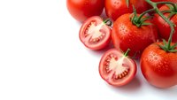 Fresh red tomatoes with water droplets and sliced halves on white background, organic vegetables for healthy cooking and nutrition.