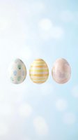 Three pastel Easter eggs with polka dots and stripes on soft gradient background for spring holiday decorations and greeting cards.