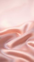 Soft pink silk fabric with elegant flowing waves and luxurious texture creating dreamy romantic background for fashion and beauty projects.