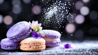 French macarons in purple and peach colors with fresh flowers and powdered sugar falling against dark background with bokeh lights creating magical atmosphere.