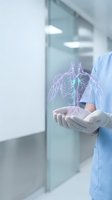 Medical professional holding glowing digital lungs hologram in modern hospital setting for healthcare technology and respiratory medicine concepts.