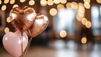 Rose gold and pink heart-shaped balloons against blurred bokeh lights background create romantic atmosphere for Valentine's Day, wedding or anniversary celebration.