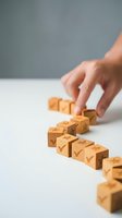 Hand arranging wooden blocks with checkmarks in row representing business success steps and goal achievement process for corporate planning.