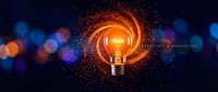 Glowing lightbulb surrounded by swirling orange sparks and particles on dark blue background with bokeh lights, representing innovation and creative ideas.