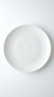 Empty white ceramic plate on neutral background, isolated and ready for food styling, product mockups, restaurant menus, and dinnerware design projects.