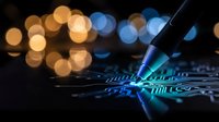 Futuristic circuit board with glowing blue light beams and colorful bokeh lights creating high-tech digital technology atmosphere for modern electronics design.