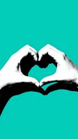 Hands forming a heart shape in black and white contrast against a vibrant teal background, symbolizing love, care, and connection.
