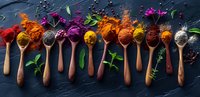Colorful spices and herbs in wooden spoons arranged in row on dark stone background, overhead panoramic view perfect for cooking blog, restaurant menu or food packaging design.