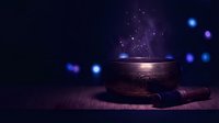 Mystical singing bowl with glowing particles and magical light effects on dark background for meditation and spiritual wellness practices.