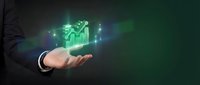 Businessman hand holding glowing green financial growth chart with upward arrow and data analytics icons, representing profit increase and market success.