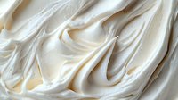 Creamy white frosting swirls with smooth texture and flowing curves for bakery desserts and culinary applications.