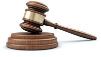 Wooden judge gavel with brass band and sound block on white background, symbol of law, justice and judicial decisions in courts and auctions.
