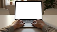 Professional businessman typing on laptop with blank white screen at modern office desk for business presentations and mockup designs.
