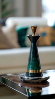 Elegant emerald green decorative bottle with gold accents on marble and glass surface, featuring luxurious geometric design for modern home decor styling.