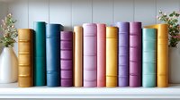 Colorful hardcover books arranged on white shelf with small vase of flowers, featuring pastel and vibrant spines in pink, blue, purple, yellow and turquoise tones.