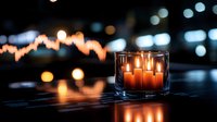Glowing orange candles in glass holder on dark background with blurred bokeh lights creating cozy atmospheric mood for relaxation and meditation.
