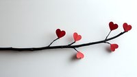 Minimalist branch with red heart-shaped leaves on white background, romantic nature concept for Valentine's Day cards and love-themed designs.