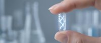 Hand holding transparent test tube with DNA double helix structure in modern laboratory setting for scientific research and biotechnology applications.