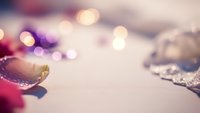 Festive holiday ornaments with warm bokeh lights creating magical Christmas atmosphere for seasonal decorations and greeting cards.