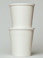 Two stacked beige paper cups isolated on neutral background for takeaway coffee tea beverages restaurant cafe branding mockup design projects.