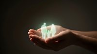 Hands holding glowing house with family silhouettes representing home insurance, real estate protection, and family security concept for financial planning.