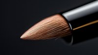 Macro shot of professional makeup brush tip with soft brown bristles against dark background, highlighting texture and precision of cosmetic tool for beauty industry.