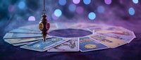 Mystical pendulum swinging over a circle of tarot cards on a dark purple velvet surface with glowing bokeh lights and smoke.