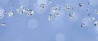 Sparkling water droplets floating on a soft blue bokeh background, creating a fresh, clean, and serene atmosphere for beauty or wellness designs.