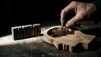 Male hand arranging wooden letter blocks spelling "MIND" next to wooden puzzle piece filled with seeds, symbolizing mental health, personal growth, mindfulness and psychological wellness concepts.