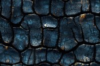 Dramatic dark blue cracked surface with deep black crevices creating abstract geometric pattern. Textured background shows weathered, aged appearance.