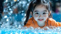 Young Asian girl in orange shirt smiling with glasses against blue bokeh background with sparkling water droplets and magical lighting effects.