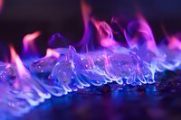 Vibrant purple and blue flames dance across dark background creating mystical atmosphere with ethereal glow and dynamic movement patterns for creative design projects.
