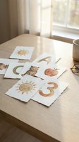 Educational flashcards with numbers and cute illustrations spread on wooden table in bright natural light for early childhood learning and development.