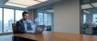 Professional businessman in navy suit working on laptop in modern glass office conference room with city skyline view during daytime meeting preparation.