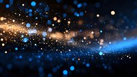 Magical glowing particles with blue and gold bokeh effect floating in dark space create atmospheric abstract background for festive designs.