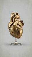 Golden anatomical heart model on stand against neutral background for medical education and healthcare presentations.