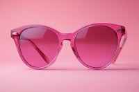Stylish pink transparent sunglasses with gradient lenses on matching background for fashion accessories and eyewear concepts.