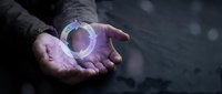 Close-up of hands holding glowing purple orb with magical light effect, representing energy, innovation, and future technology concepts for design projects.