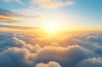 Majestic aerial view above fluffy white clouds during golden sunset with vibrant orange and blue sky, creating ethereal atmosphere for spiritual and peaceful concepts.