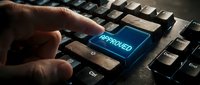 Close-up of hand pressing blue approved button on dusty mechanical keyboard, symbolizing confirmation, authorization, and acceptance in digital workflow and business processes.
