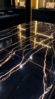 Luxury retail showroom with polished black marble flooring featuring gold veining, warm ambient lighting, and display cases showcasing handbags and accessories.
