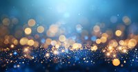 Magical glowing golden and blue bokeh lights on dark background with sparkling particles creating dreamy festive atmosphere. Suitable for holiday designs.