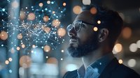 Young African American businessman with beard and glasses looking at futuristic network visualization with glowing dots and connections against blurred bokeh lights background.