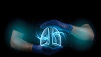 Medical professional hands protecting glowing lung anatomy hologram on dark background representing healthcare technology and respiratory system care.