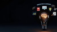 Light bulb with brain inside surrounded by floating business icons representing innovation and e-learning concepts on dark background.