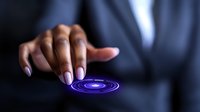 African American businesswoman finger touching glowing blue digital circle interface on dark background, futuristic technology concept.